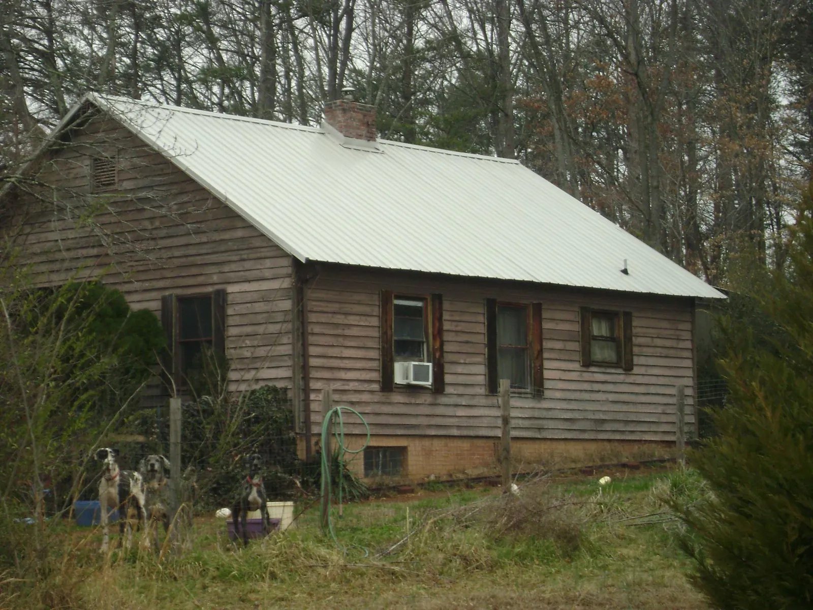White metal roof on an old wood sided farmhouse, from a Metal Roof Installation job in Ellaville